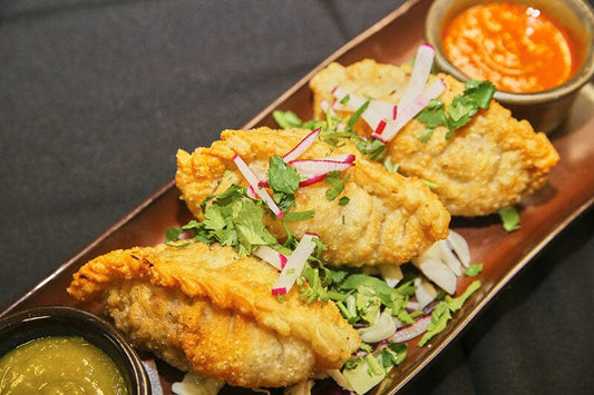 Hand-Crimped Empanadas with Fresh Garnish and Green Salsa